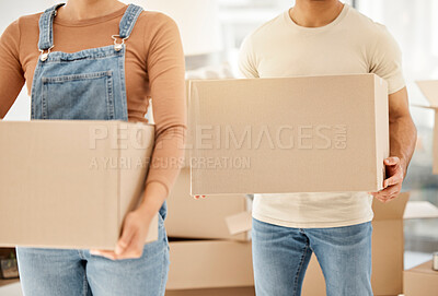 Buy stock photo Closeup shot of an unrecognisable couple carrying boxes while moving house