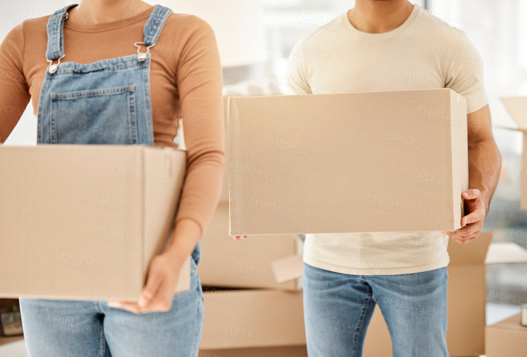 Buy stock photo Hands, people and moving with boxes in home, teamwork or packing for real estate. Couple, together and collaboration in property with cardboard container, mortgage loan or investment in house