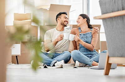 Buy stock photo Shot of a young couple sitting on the floor and drinking coffee while moving house