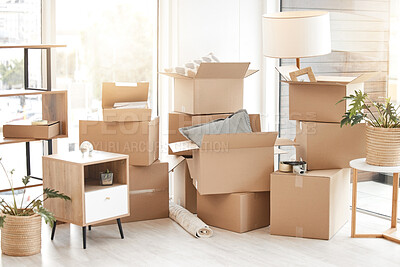 Buy stock photo Cardboard, moving boxes and packing house with furniture, living room decorations and apartment space. Household, packed box and empty property to rent, buy or new home with modern interior 