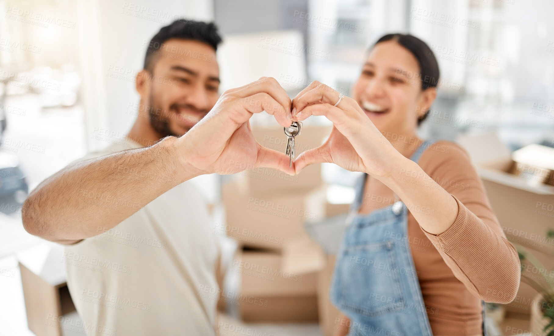 Buy stock photo Hands, heart and keys as couple in new house success, real estate and love for gratitude of property investment. Happy, woman and man with care emoji, support and lock security  for homeowner bonding