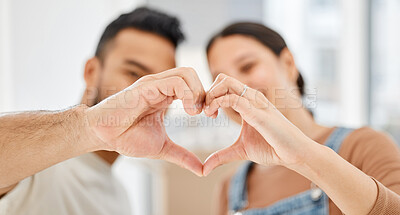 Buy stock photo Closeup shot of a couple making a heart shape with their hands while moving house