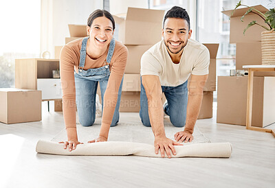 Buy stock photo Portrait of a young couple rolling out a carpet together in their new home