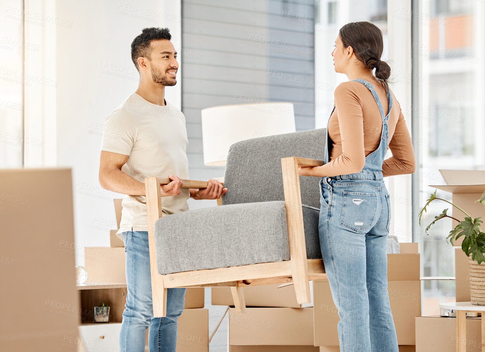 Buy stock photo Smile, couple and moving furniture in new house for renovations, boxes and bonding of property interior design. People, relationship and cardboard, support or helping with sofa decoration of lounge

