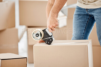 Buy stock photo Closeup shot of an unrecognisable man using  a tape dispenser while moving house