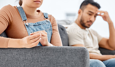 Buy stock photo Closeup shot of a woman removing her wedding ring from her finger during an argument with her partner at home