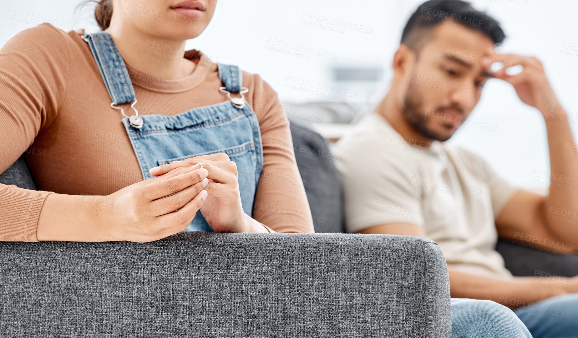 Buy stock photo Couple, hands and woman with wedding ring on sofa for conflict, separation or relationship crisis in living room. Doubt, marriage and sad wife with man for divorce, infidelity or breakup in home