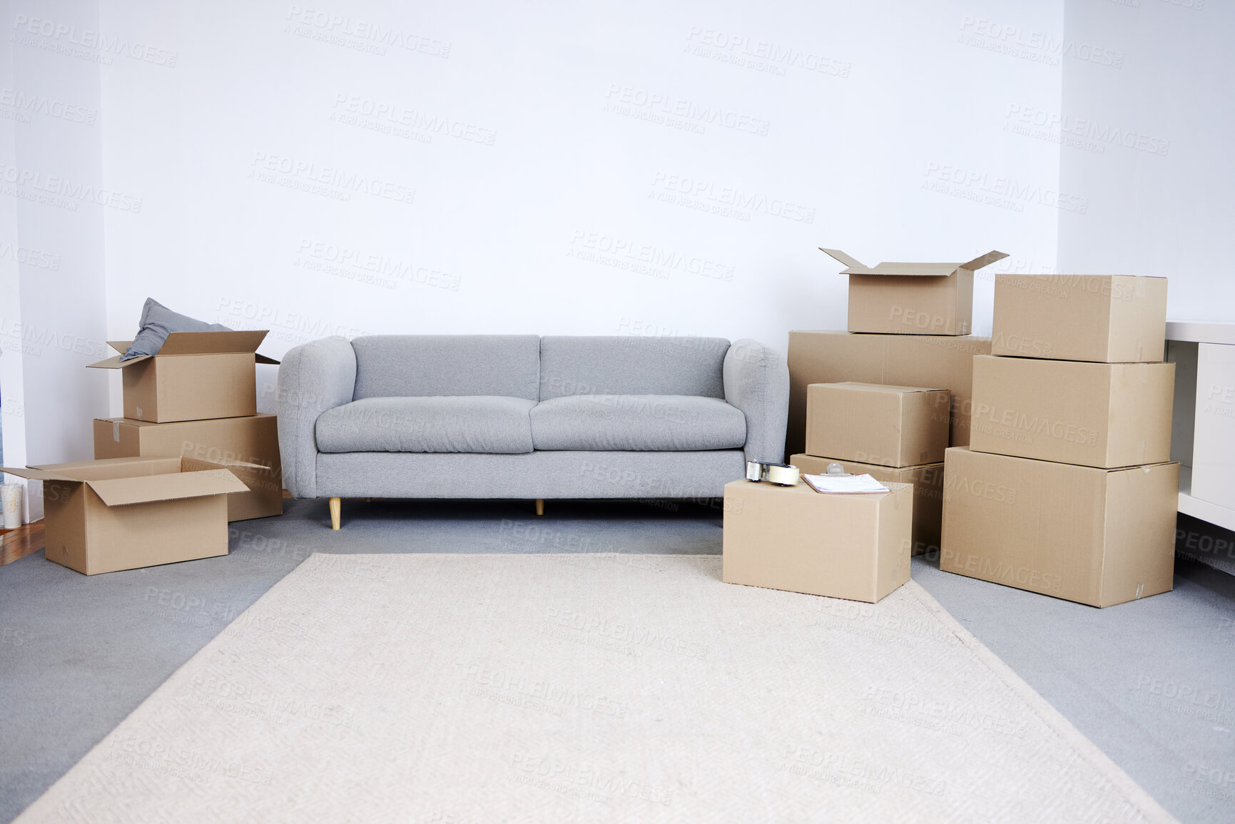 Buy stock photo Living room, house and sofa with boxes for moving, investment for future or financial growth. Empty lounge, cardboard container and couch with storage for property goal, apartment with mortgage loan