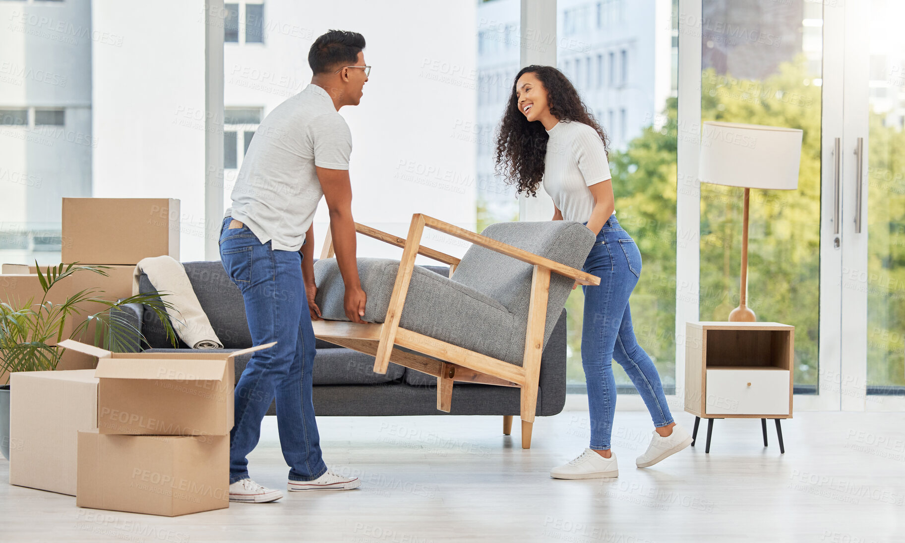 Buy stock photo Happy, couple and moving furniture in new house for renovations, boxes and bonding for property interior design. People, relationship and cardboard, support and helping with sofa decoration of lounge