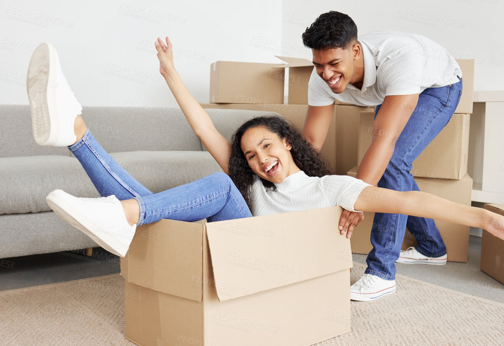 Buy stock photo Real estate, happy couple and push in box to celebrate new home, mortgage and investment together. Portrait, man and excited woman in cardboard for property rental, moving and play game in apartment