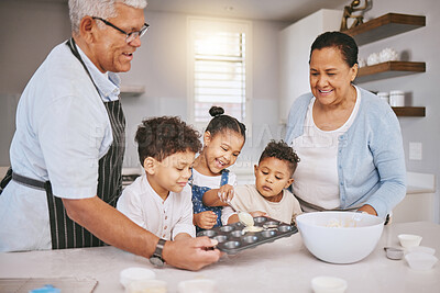 Buy stock photo Shot of a mature couple baking with their grandkids at home