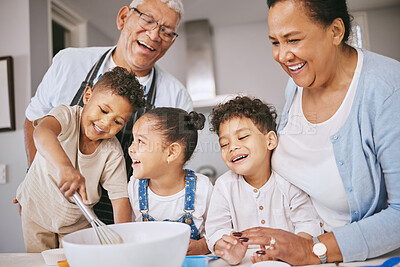 Buy stock photo Shot of a mature couple baking with their grandkids at home