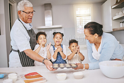 Buy stock photo Shot of a mature couple baking with their grandkids at home