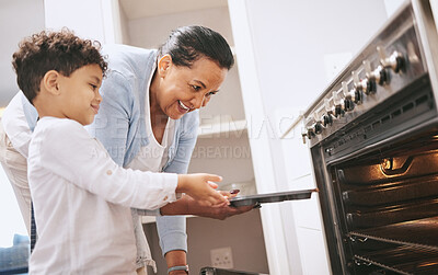 Buy stock photo Shot of a mature woman helping her grandchild safely open the oven at home