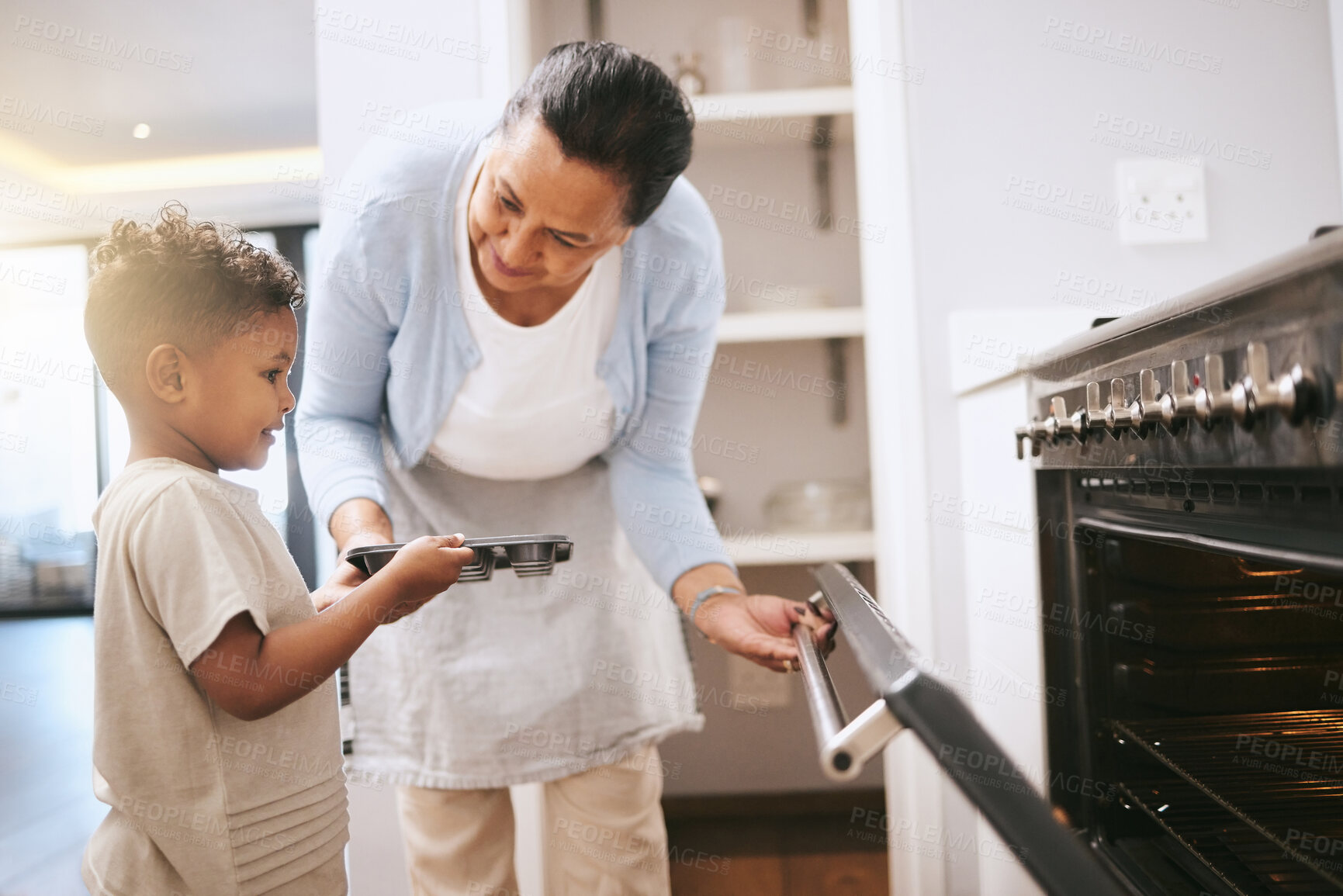 Buy stock photo Oven, cooking and grandmother with boy, tray and care for teaching with secret recipe or bonding together. Family home, helping and mature granny with equipment for dessert food, kitchen and learning