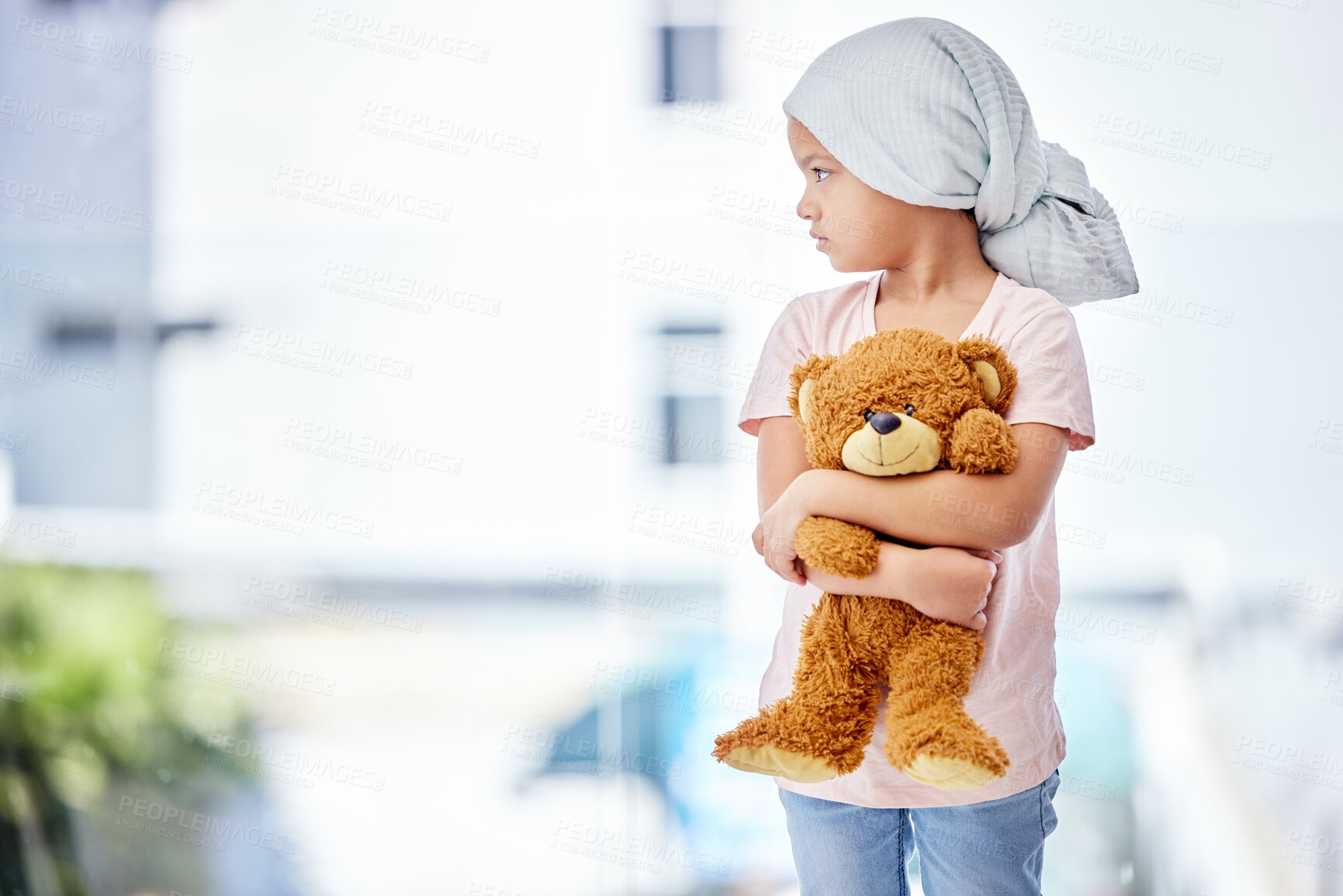 Buy stock photo Healthcare, teddy bear and child cancer patient holding her toy for support or comfort. Medical, recovery and girl kid with leukemia standing after treatment or chemotherapy in a medicare hospital.