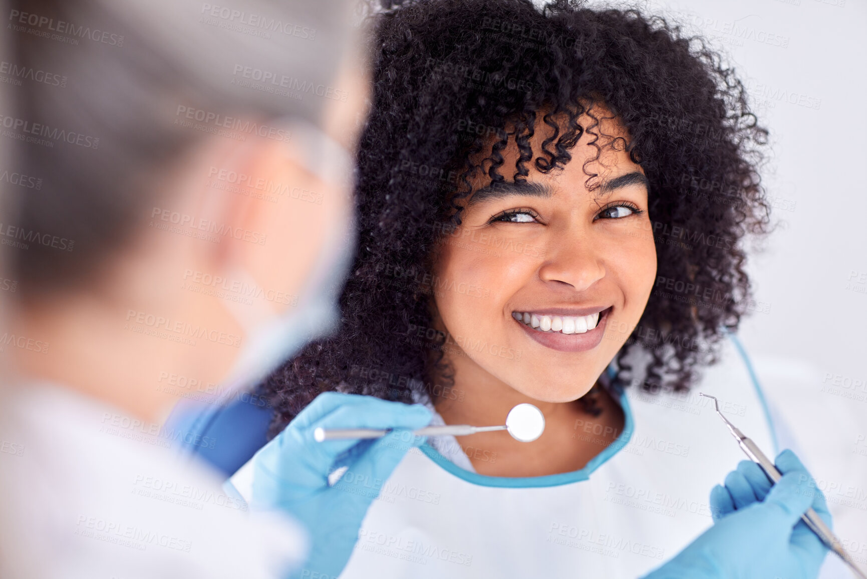 Buy stock photo Shot of a young female patient having her teeth examined at the dentist