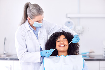 Buy stock photo Shot of a young female patient having her teeth examined at the dentist