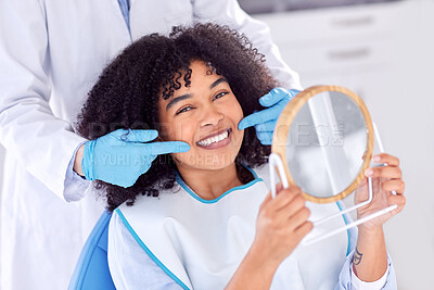 Buy stock photo Shot of a young woman checking her dental work in a mirror