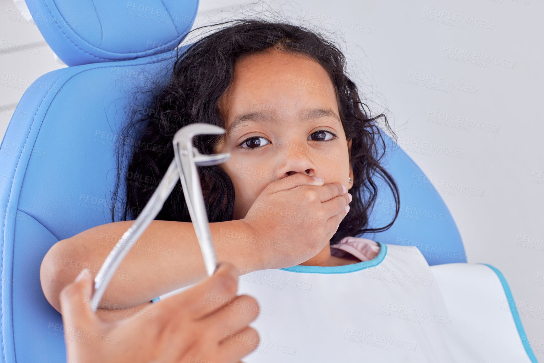 Buy stock photo Shot of a young girl looking scared while having dental work done on her teeth