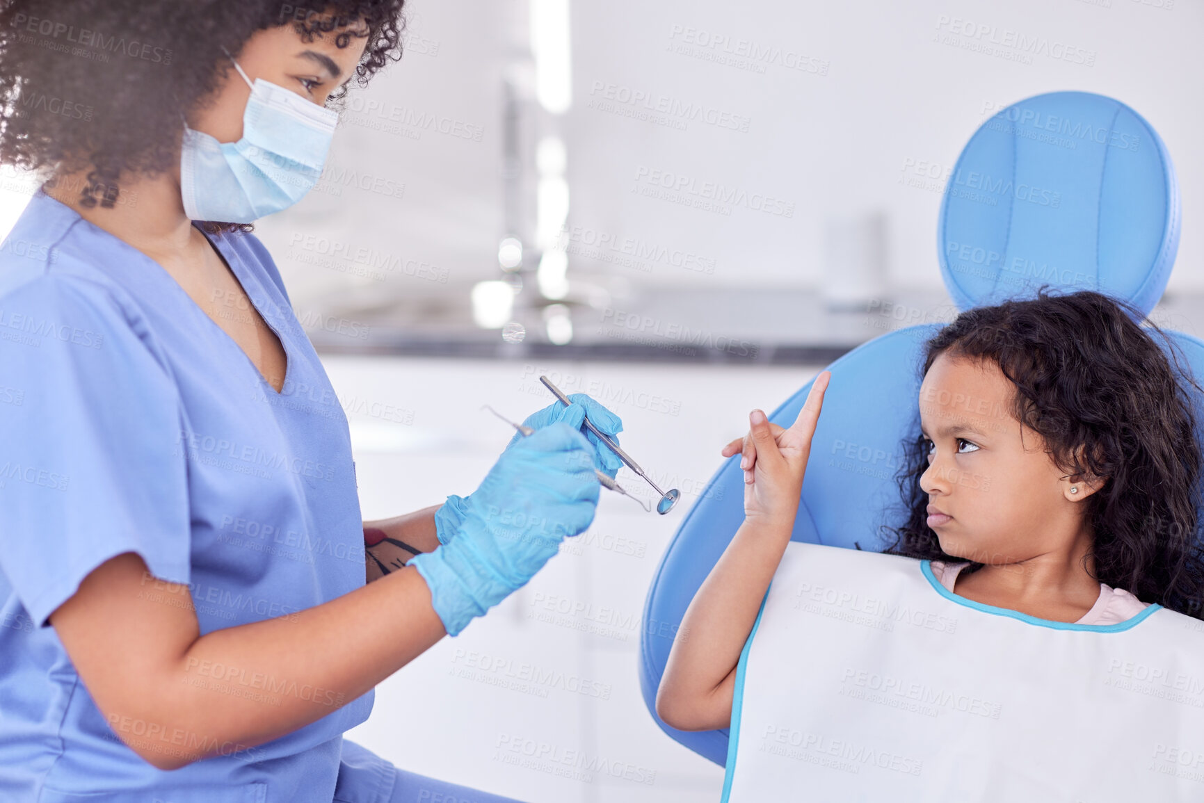 Buy stock photo Shot of a little girl looking upset at the dentist