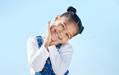 Buy stock photo Portrait, girl and child or happy in studio with confidence, pride and adorable in casual fashion. Kid, face and smile with trendy outfit, positive expression or shy on blue background mockup space