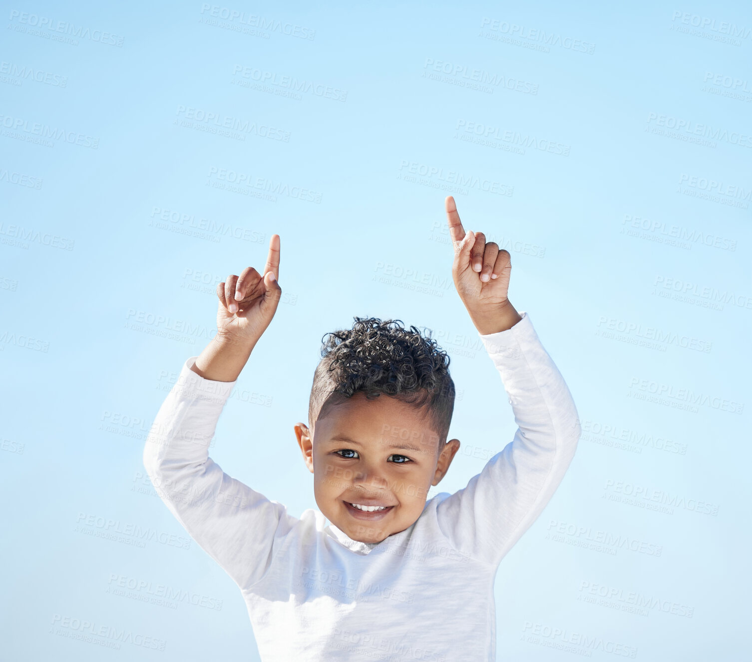 Buy stock photo Shot of an adorable little boy pointing to the sky