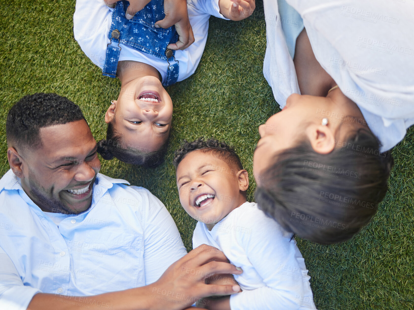 Buy stock photo Parents, children and lying on grass with laughing, tickling and game with connection on vacation. People, mother and father with kids on lawn at park, garden and above with playful family in Brazil