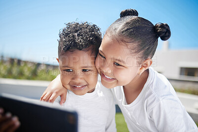 Buy stock photo Shot of an adorable brother and sister taking a selfie together while bonding outside