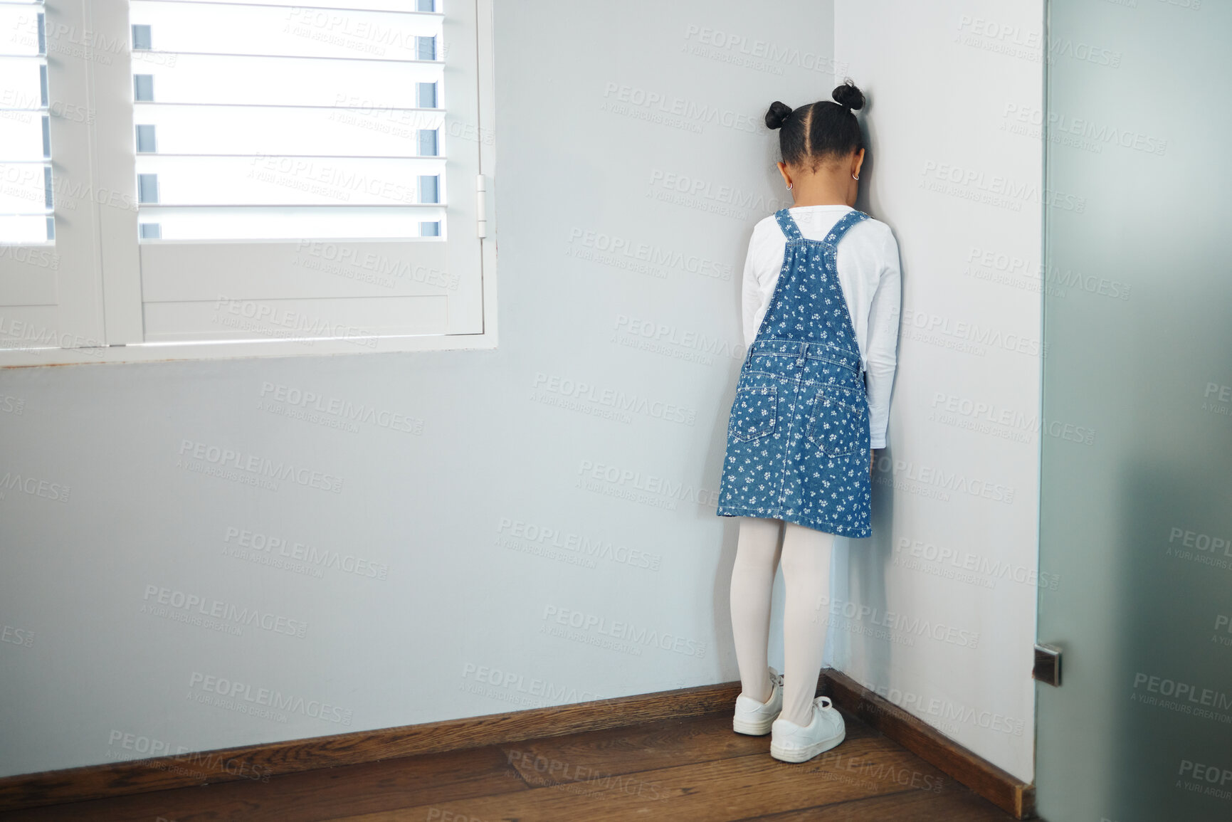 Buy stock photo Little girl, punishment and corner with wall in time out for tantrum, attitude or discipline in room at home. Back view, child or kid facing blank space for naughty behaviour or disciplinary action