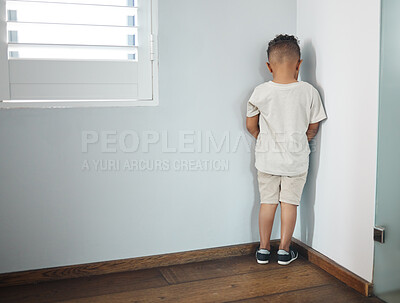 Buy stock photo Naughty child, boy and back to wall in home for punishment, behavior and discipline. Kid, person with adhd and standing in corner of living room for time out, tantrum and expression of guilt in house