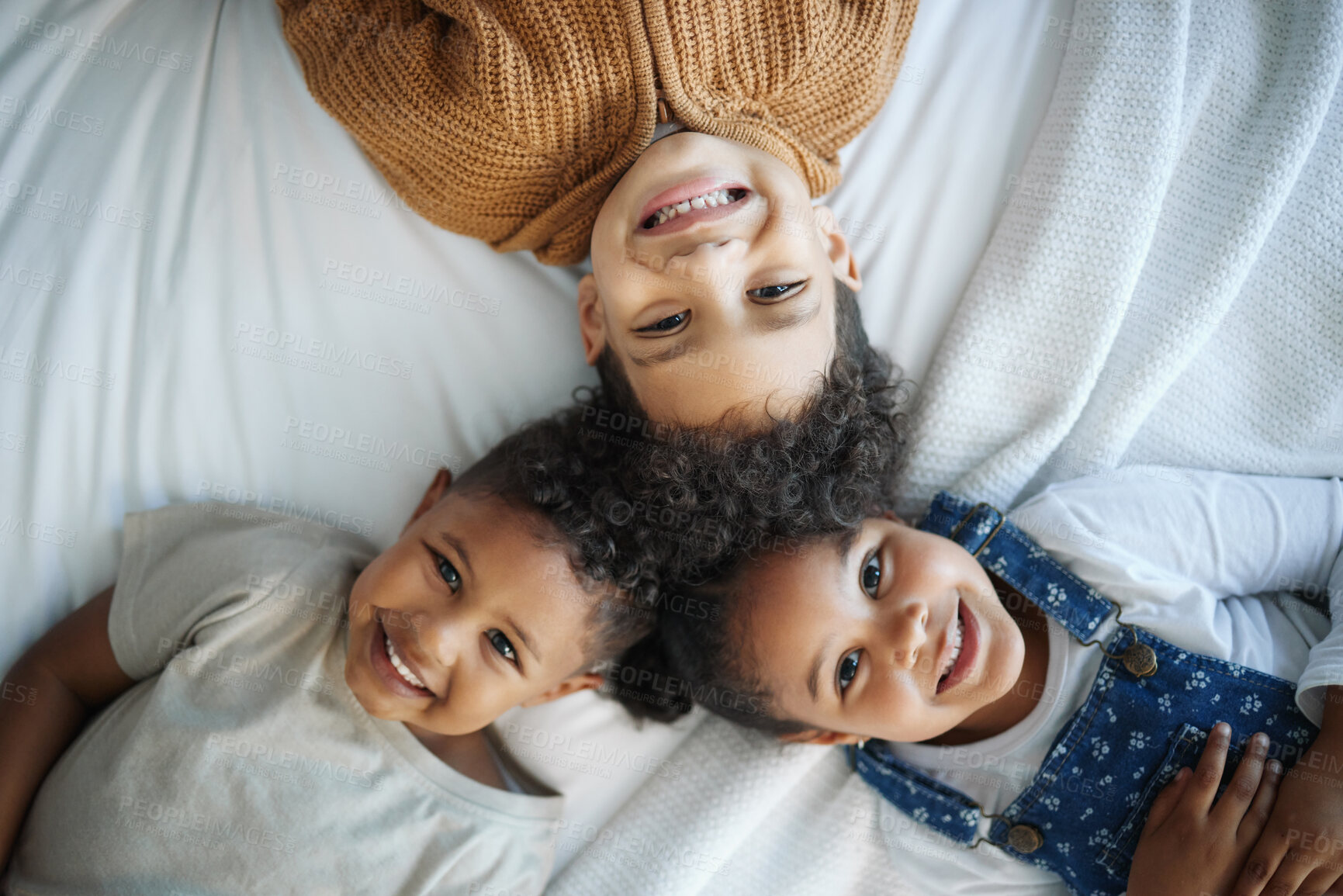 Buy stock photo Children, smile and above bed in circle with siblings, connection and relax in morning at family house. Kids, brother and sister with lying, portrait and happy with love at apartment in Mexico