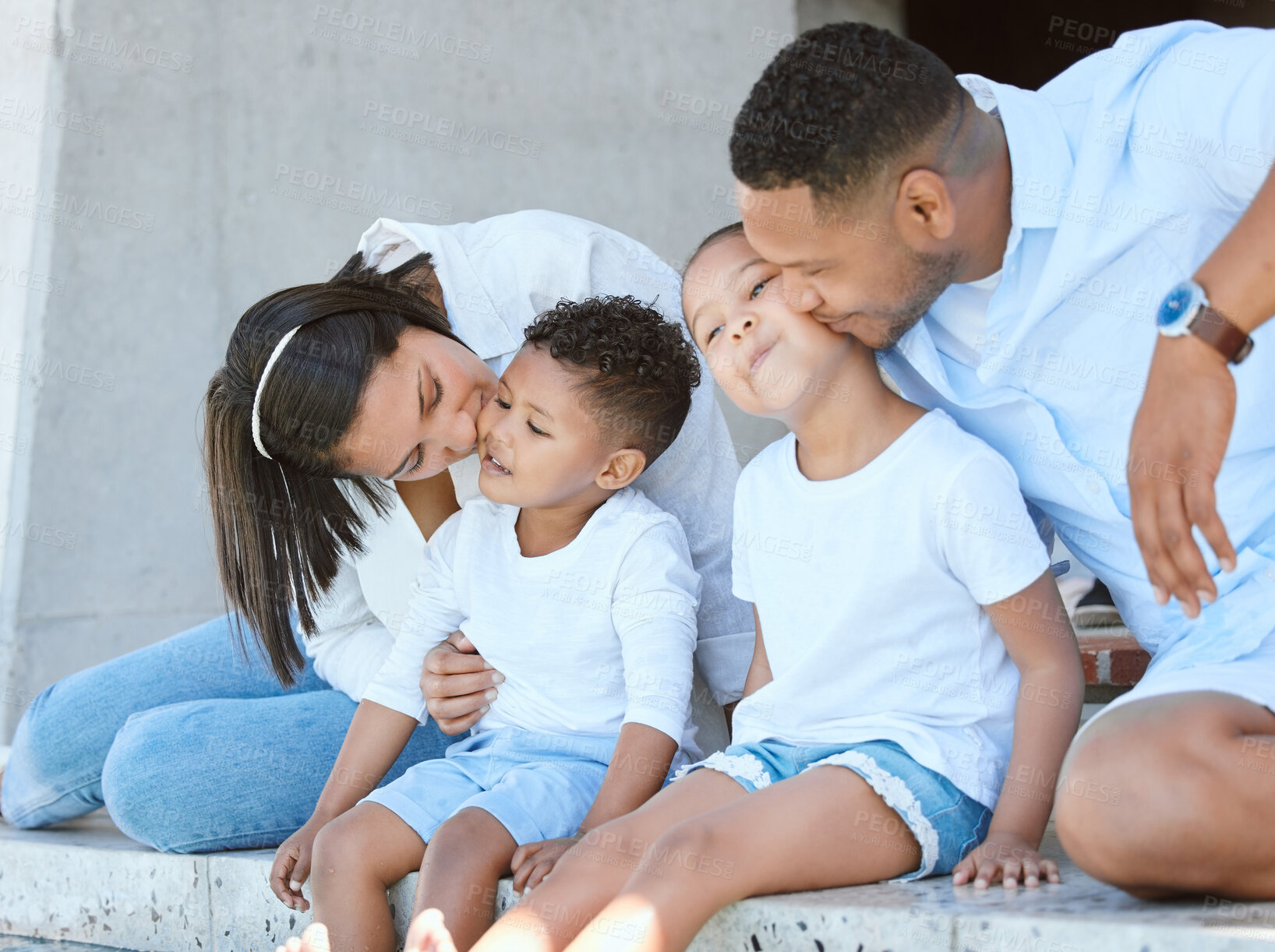 Buy stock photo Family, kiss and happy outdoor for travel, bonding and tropical holiday with summer, love and fun. Parents, people and children outside for getaway vacation, relationship and adventure in Santorini