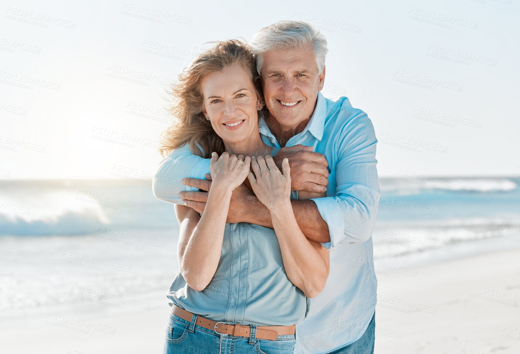 Buy stock photo Senior, couple and portrait hug at the beach for happiness and bond in the outdoor. Mature, man and woman holding one another at the ocean with smile and love for vacation and travel in summer