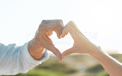 Buy stock photo Cropped shot of an unrecognizable couple forming a heart shape with their hands