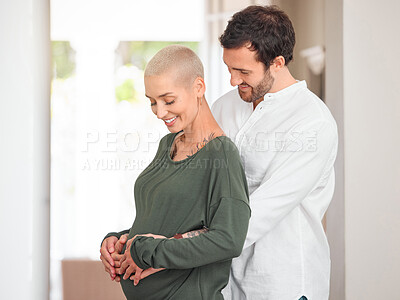 Buy stock photo Cropped shot of an affectionate young couple standing with their hands on the expectant mother's belly