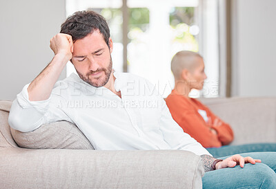 Buy stock photo Cropped shot of a handsome young man looking dejected after arguing with his wife at home