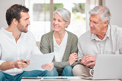Buy stock photo Cropped shot of a handsome young male financial advisor helping a senior couple with their finances in their home