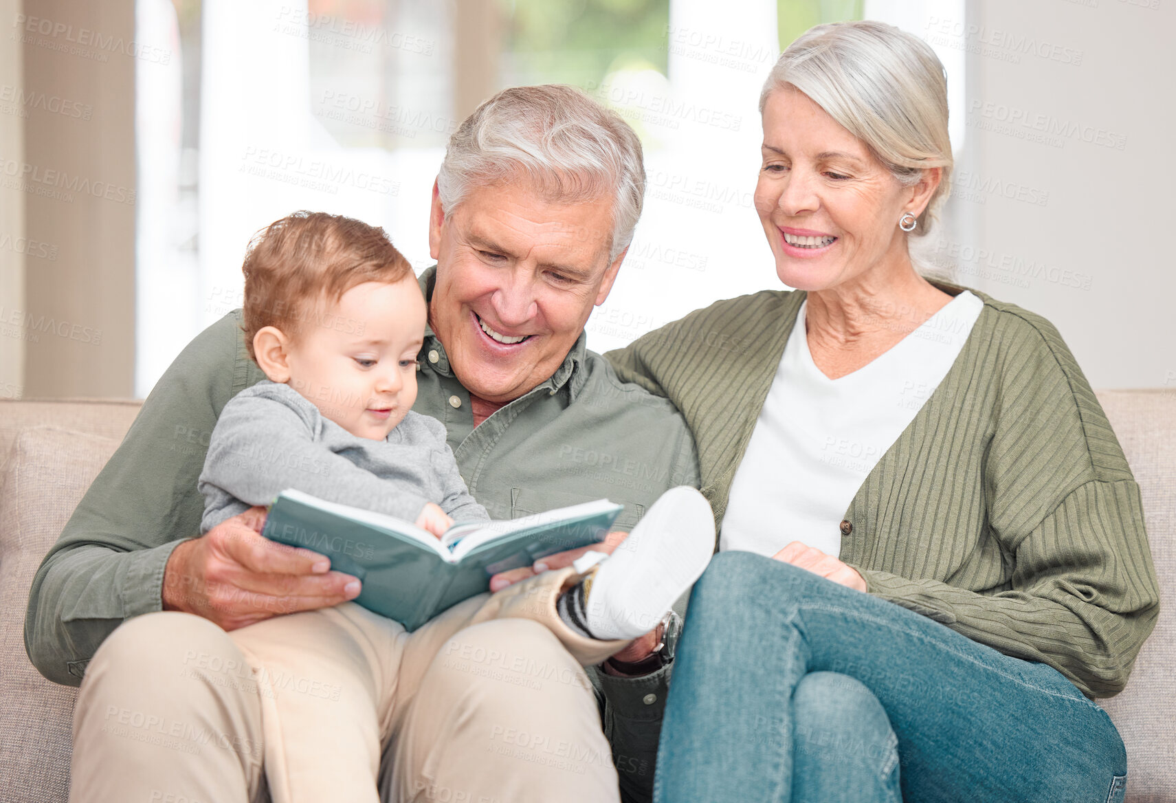 Buy stock photo Grandparents, boy and storytelling on sofa in home for fun, bonding and care with fantasy. Pensioners, toddler and kid on learning with book reading for knowledge, information and child growth