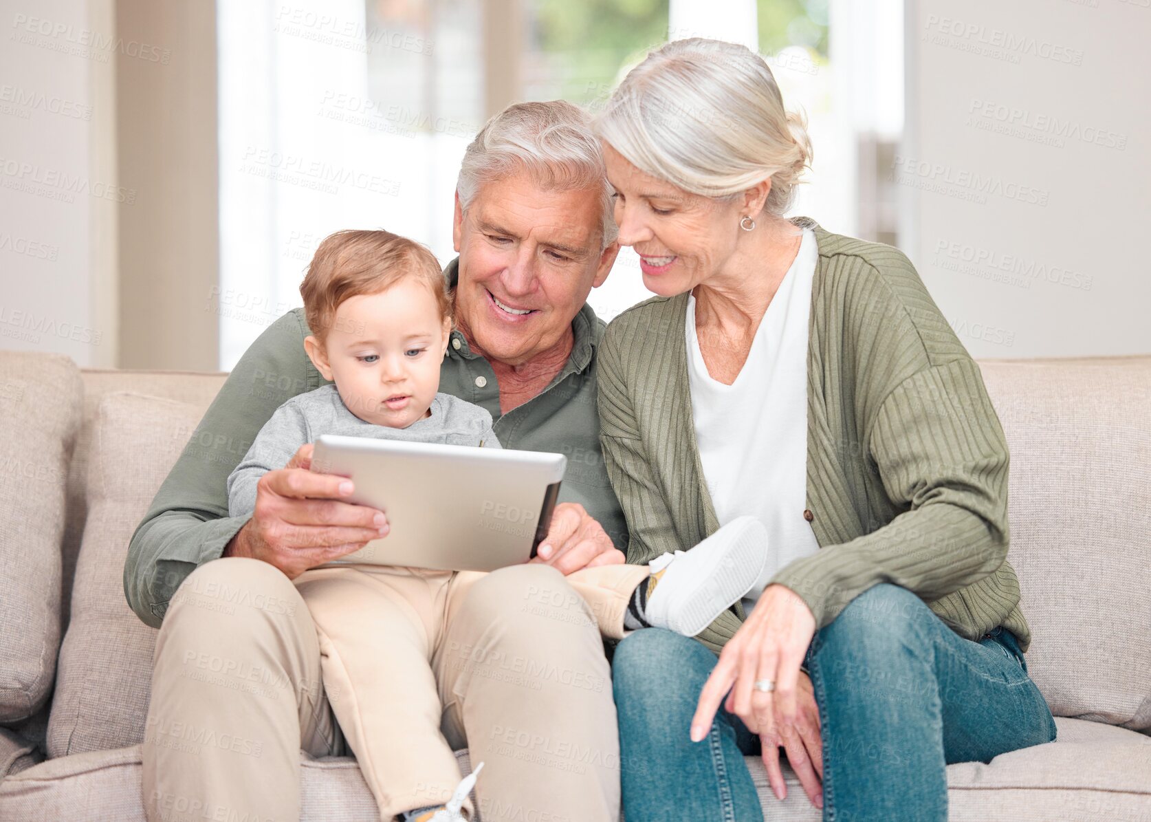 Buy stock photo Grandparents, boy and happy with storytelling on tablet at home for fun, bonding and care with fantasy. People, toddler and kid on learning with ebook for knowledge, information and child growth