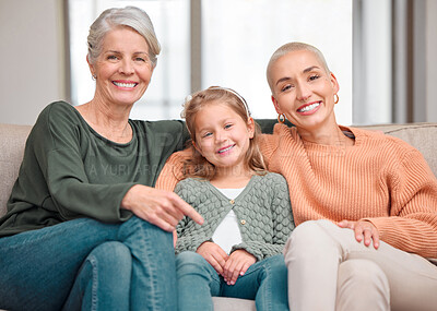 Buy stock photo Portrait of a mature woman bonding with her daughter and granddaughter on the sofa at home