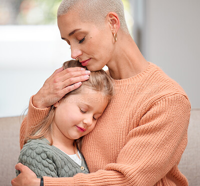 Buy stock photo Shot of a young mother comforting her daughter on the sofa at home