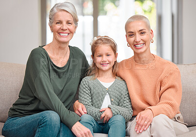 Buy stock photo Portrait of a mature woman bonding with her daughter and granddaughter on the sofa at home