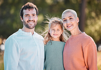Buy stock photo Shot of a young couple and their daughter spending time outdoors