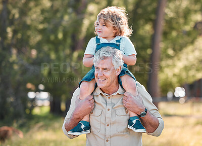 Buy stock photo Shot of a senior man carrying his grandson on his shoulders