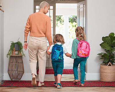 Buy stock photo Shot of a woman leaving home with her two children