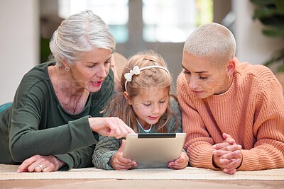 Buy stock photo Pointing, streaming and tablet with family in living room of home together for download or education. Girl, grandma and mother on floor in apartment for child development, growth or learning