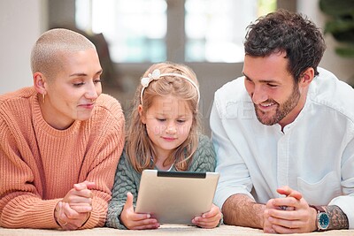 Buy stock photo Smile, tablet and video with family in living room of home together for education or online streaming. Happy girl, mother and father on floor in apartment for child development, growth or learning