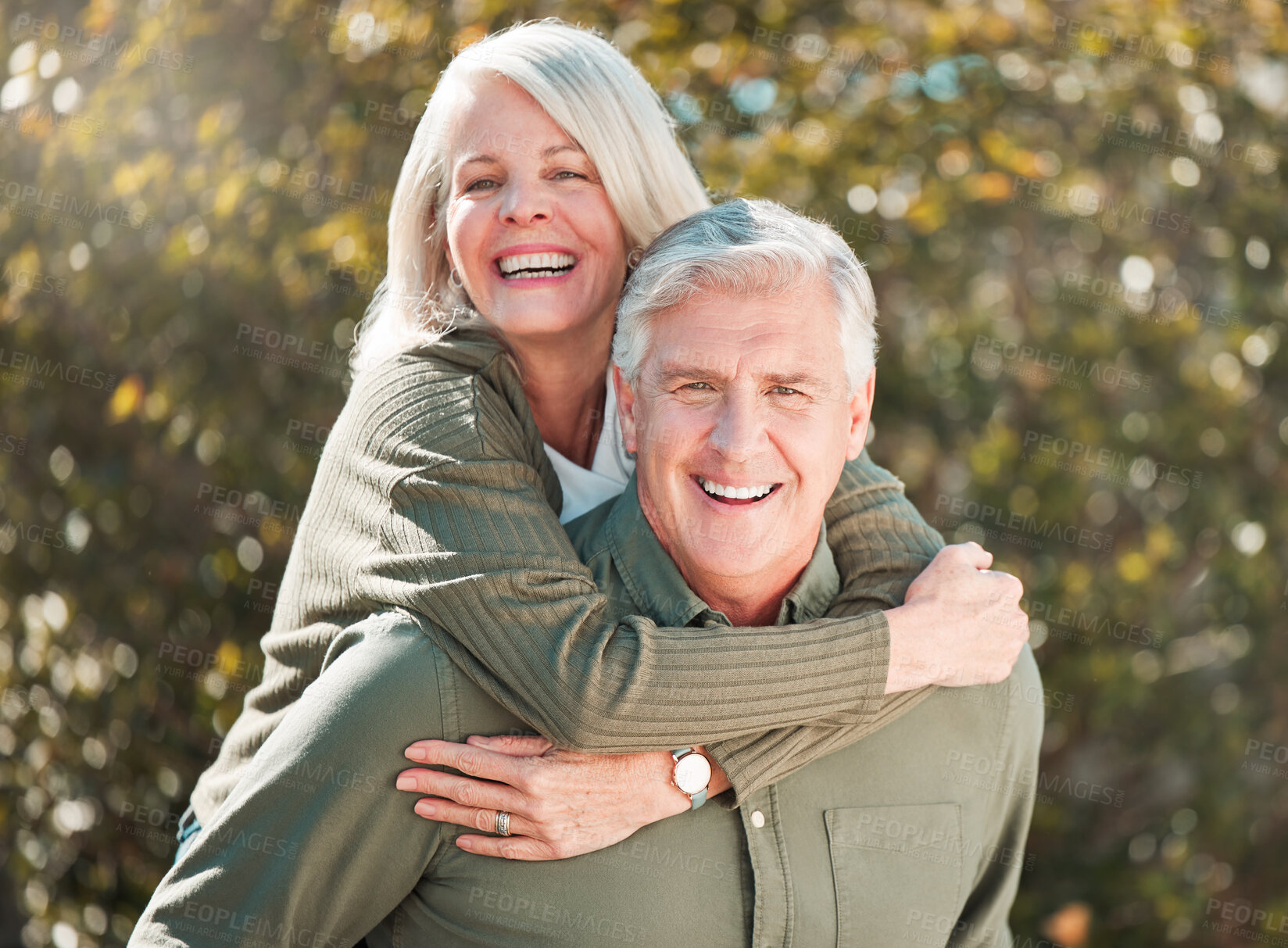 Buy stock photo Cropped portrait of a handsome mature man piggybacking his wife outdoors