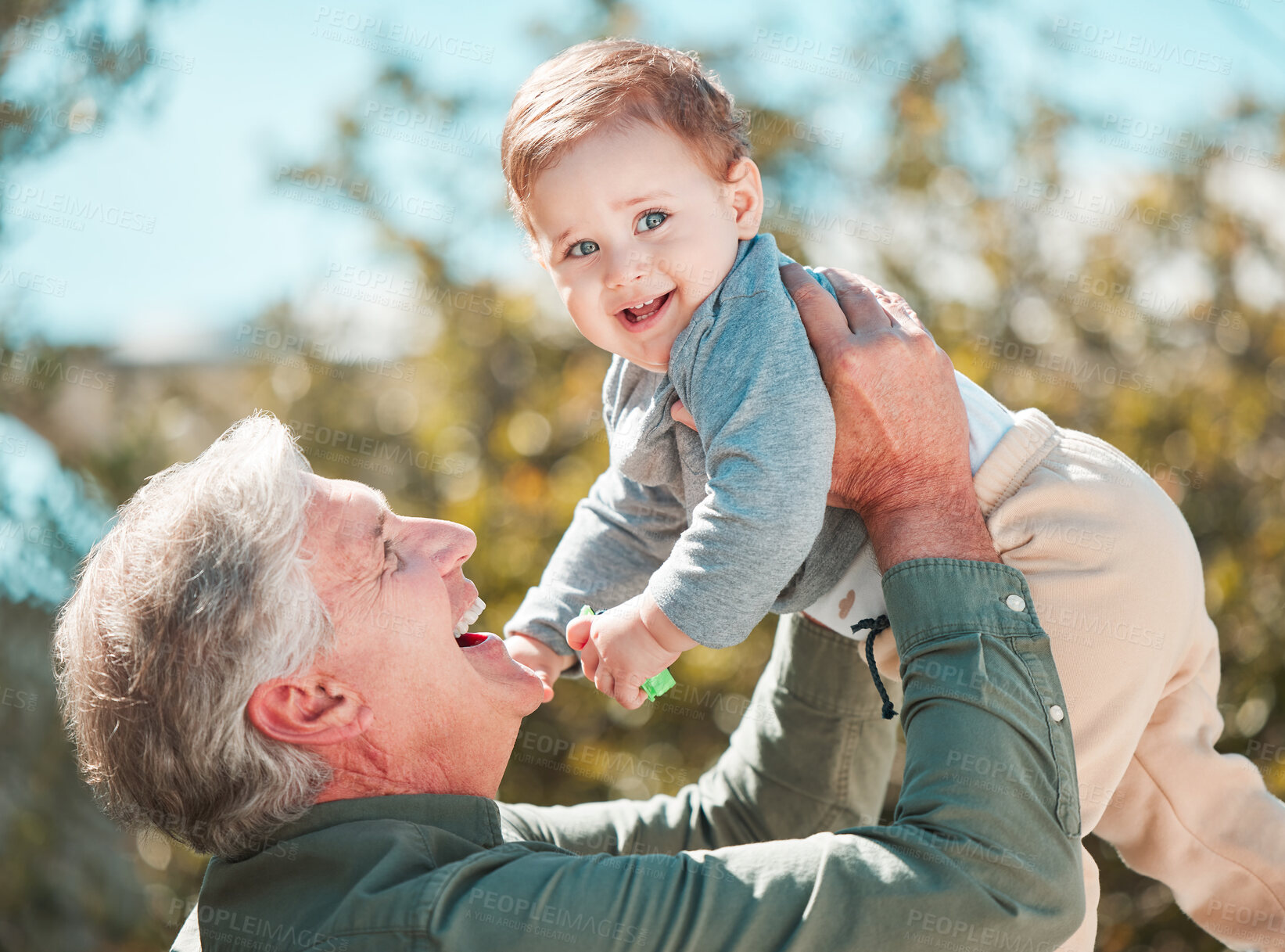 Buy stock photo Cropped shot of a handsome mature man and his grandson outdoors